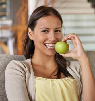 Healthy woman holding apple