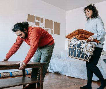 A couple organizing furniture in an apartment