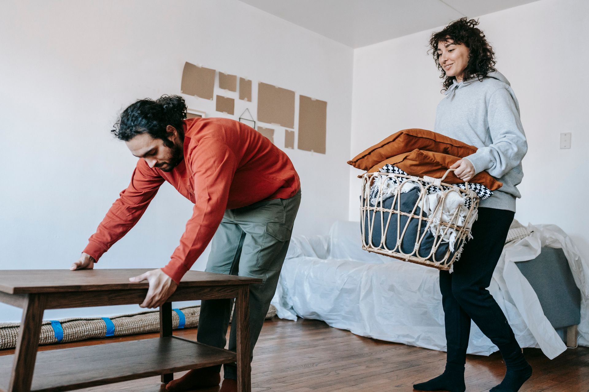 A couple organizing furniture in an apartment
